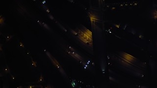DCA08_377 - 4K aerial stock footage of a bird's eye of city streets and skyscrapers, reveal the freeway, Downtown San Diego, California, Night
