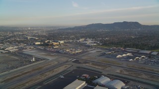 DCLA_001 - 5K aerial stock footage approach runways and terminals at Burbank Airport at sunset, California
