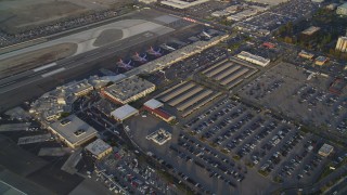 DCLA_004 - 5K aerial stock footage orbit main terminals and parking lots at sunset at Burbank Airport, California