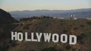 DCLA_007 - 5K aerial stock footage tilt to reveal and fly over the Hollywood Sign at sunset, California