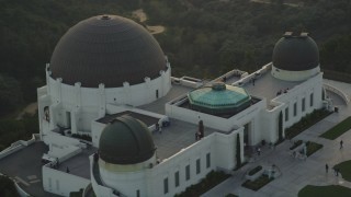 DCLA_008 - 5K aerial stock footage orbit the Griffith Observatory with people on the grounds at sunset, California