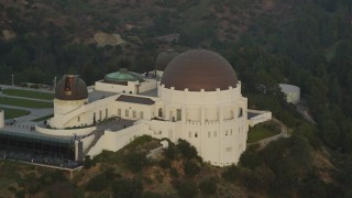 DCLA_012 - 5K aerial stock footage orbit west side and front of the Griffith Observatory at sunset, California