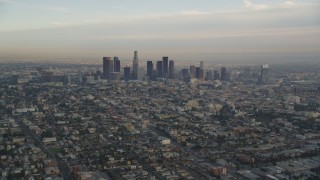 DCLA_013 - 5K aerial stock footage tilt from heavy traffic on the 101 to reveal the Downtown Los Angeles skyline at sunset, California
