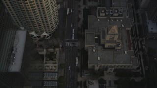 DCLA_017 - 5K aerial stock footage video fly over skyscrapers and tilt to reveal 5th Street and the Los Angeles Public Library at sunset, California