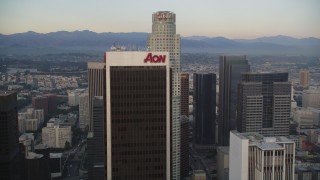 DCLA_043 - 5K aerial stock footage tilt from high-rises, reveal and approach Aon Center and US Bank Tower at twilight in Downtown Los Angeles, California