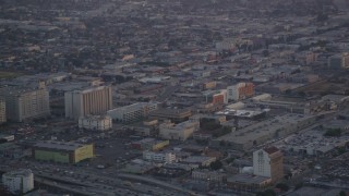 DCLA_051 - 5K aerial stock footage track a police helicopter flying over Downtown Los Angeles at twilight, California