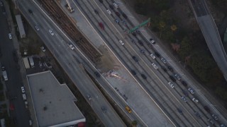 DCLA_060 - 5K aerial stock footage bird's eye view of tracking police helicopter over freeway at twilight in Downtown Los Angeles, California