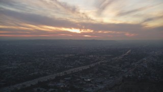 DCLA_067 - 5K aerial stock footage of setting sun over Interstate 10 and suburbs in Mid-City Los Angeles, California