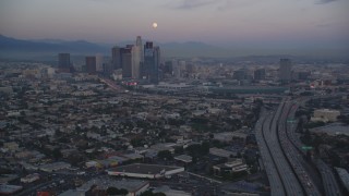 DCLA_069 - 5K aerial stock footage of moon over Downtown Los Angeles skyline seen from I-10 at twilight, California