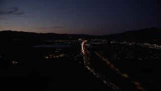 DCLA_089 - 5K stock footage aerial video approach interchange with the 5 and 405 freeways in Sylmar at night, California