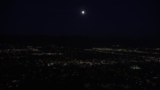 DCLA_094 - 5K stock footage aerial video of full moon over suburban neighborhoods in the San Fernando Valley at night, California