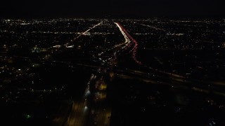 DCLA_096 - 5K aerial stock footage fly over I-5, tilt to reveal 118 interchange at night in San Fernando, California
