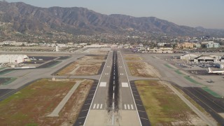 DCLA_103 - 5K stock footage aerial video tilt to reveal and approach runway at Burbank Airport, California