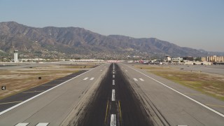 DCLA_104 - 5K aerial stock footage tilt and fly over the runway at Bob Hope International Airport in Burbank, California