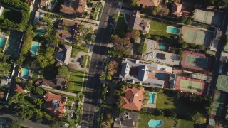 DCLA_117 - 5K aerial stock footage of a bird's eye view of a street lined with mansions in Beverly Hills, California
