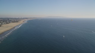 DCLA_128 - 5K aerial stock footage of sailboats and parasailers near the beach in Santa Monica, California