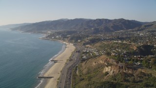 DCLA_132 - 5K aerial stock footage fly over beach and tilt up Highway 1 in Pacific Palisades, California