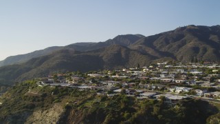 DCLA_138 - 5K aerial stock footage tilt from Highway 1 to reveal neighborhood  on cliff in Malibu, California