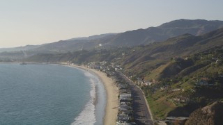 DCLA_146 - 5K aerial stock footage pan from coastal foothills to beachfront homes in Malibu, California