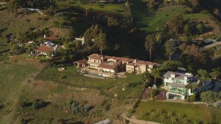 DCLA_149 - 5K aerial stock footage of reverse view of a hilltop mansion in Malibu, California