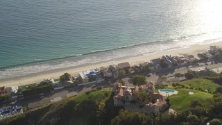 DCLA_152 - 5K aerial stock footage orbit hilltop mansion to reveal beachfront homes in Malibu, California