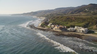 DCLA_155 - 5K aerial stock footage tilt from ocean waves to reveal oceanfront homes in Malibu, California