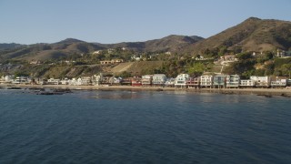 DCLA_156 - 5K aerial stock footage fly low by beachfront homes in Malibu, California
