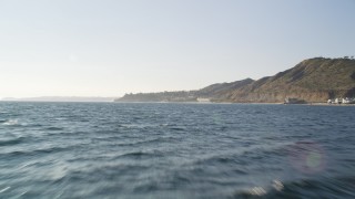 DCLA_160 - 5K aerial stock footage tilt from the blue ocean to reveal and approach the coast of Malibu, California