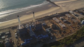 DCLA_196 - 5K stock footage aerial video fly over tanks to approach smoke stacks and beach in El Segundo, California