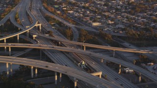 DCLA_204 - 5K aerial stock footage tilt to reveal light traffic on the 110/105 interchange in Westmont at sunset, California