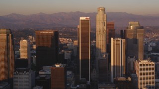 DCLA_212 - 5K aerial stock footage tilt up Hope Street to reveal skyscrapers in Downtown Los Angeles at sunset, California