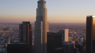 DCLA_219 - 5K aerial stock footage tilt from 110 freeway to reveal and approach US Bank Tower in Downtown Los Angeles at sunset, California