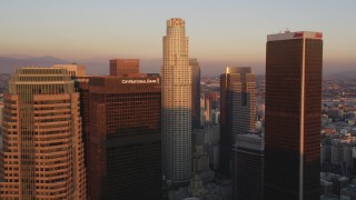 DCLA_228 - 5K aerial stock footage tilt to reveal and approach US Bank Tower and skyscrapers at sunset in Downtown Los Angeles, California