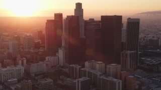 DCLA_232 - 5K stock footage aerial video tilt to reveal city hall and Downtown Los Angeles skyline at sunset, California