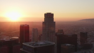 DCLA_233 - 5K aerial stock footage tilt from dark streets to reveal and approach Downtown Los Angeles towers at sunset, California