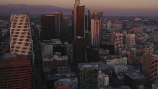 DCLA_238 - 5K aerial stock footage tilt from dark streets to reveal Downtown Los Angeles high-rises at twilight, California