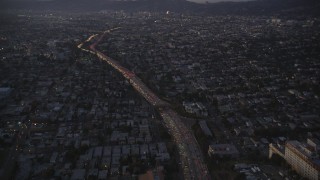 DCLA_268 - 5K aerial stock footage of tilting up heavy traffic on Highway 101 by Echo Park at twilight, California