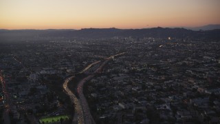 DCLA_269 - 5K aerial stock footage tilt from Highway 101 by Echo Park to reveal Hollywood at twilight, California
