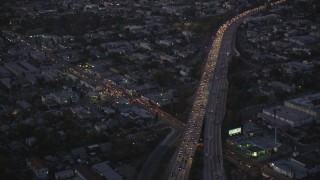 DCLA_271 - 5K stock footage video tilt from bird's eye of Highway 101 to reveal Hollywood at twilight, California