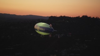 DCLA_281 - 5K aerial stock footage orbit blimp flying near the Hollywood Hills at twilight, California