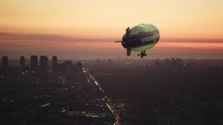 DCLA_282 - 5K aerial stock footage of tracking a blimp flying near Century City at twilight, California