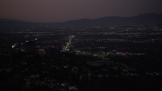 DCLA_283 - 5K aerial stock footage of Universal City office buildings seen from Hollywood Hills at night, California