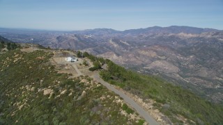 DCSF01_009 - 5K aerial stock footage Follow mountain ridge summit to cell phone tower, Santa Ynez Mountains, California