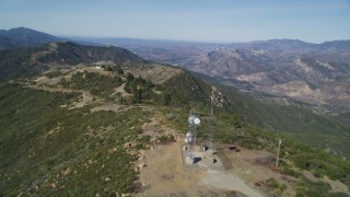 DCSF01_010 - 5K aerial stock footage Cell phone tower, antenna arrays atop mountain ridge, Santa Ynez Mountains, California