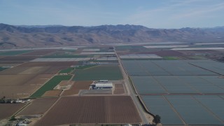DCSF02_001 - 5K aerial stock footage Fly by geometric fields of farmland, Sierra Madre Mountains, Santa Maria, California
