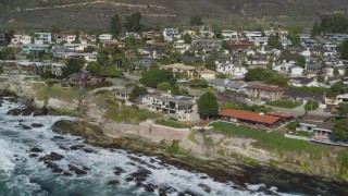 DCSF02_012 - 5K aerial stock footage Flying by oceanfront homes and waves crashing on rocky shore, Shell Beach, California