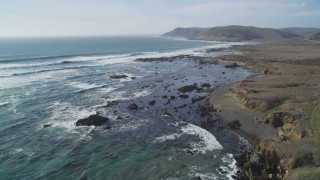 DCSF03_005 - 5K aerial stock footage Fly over coastal cliffs and crashing waves of the Pacific Ocean, Estero Bay, California