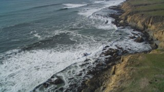 DCSF03_009 - 5K aerial stock footage Tilt from crashing waves to coastline to reveal coastal cliffs, Cambria, California