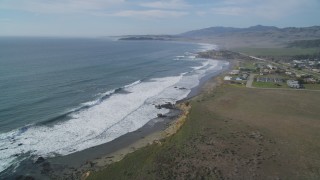 DCSF03_015 - 5K aerial stock footage Tilt to reveal ocean waves rolling into the coast, San Simeon, California