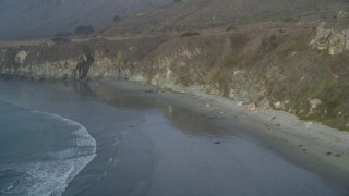 DCSF03_040 - 5K aerial stock footage Fly over deserted beach at the base of cliffs, Big Sur, California